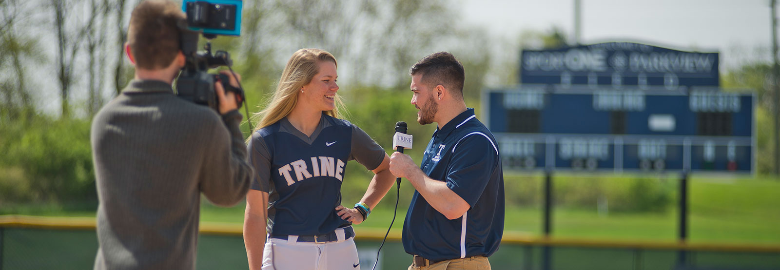 Student interviewing a softball player