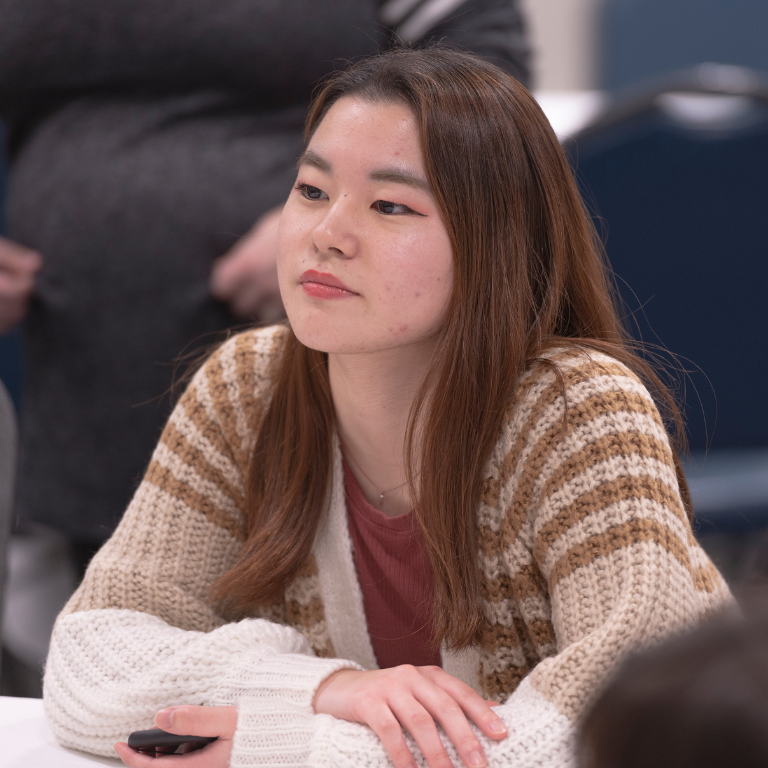 student listening to a speaker